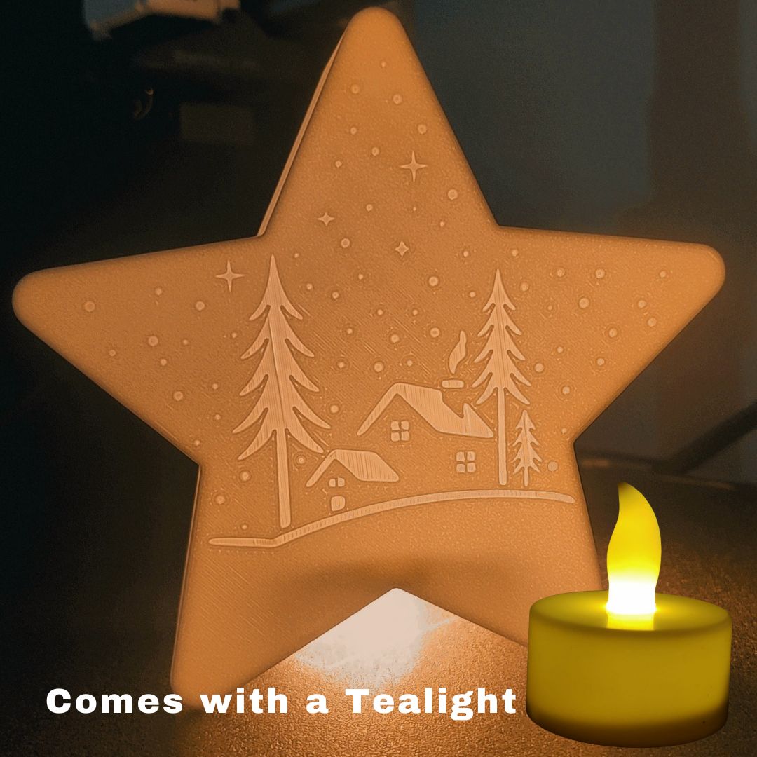 The 3D Printed Christmas Star Tealight Decor showcases a cozy winter cabin scene, softly lit from behind. A tealight candle icon and "Comes with a Tealight" text appear at the bottom. Unique holiday home decoration!.