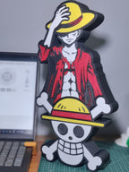 The Monkey D. Luffy 3D Printed Figurine (32 cm) showcases the anime icon in a red jacket and yellow hat, with a skull and crossbones base—ideal desk decor or collectible for any One Piece fan.